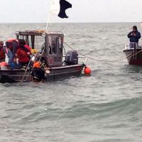 Two boats with people in water.