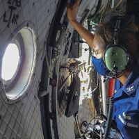 Woman looking out the window of a plane. 