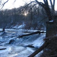Creek passing over a dam in winter.