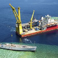 Salvage operations for grounded Navy mine ship Ex-Guardian on Philippines reef.