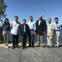 People standing together with lake in background. Image credit: NOAA.